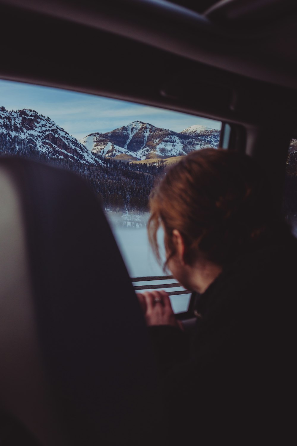 woman facing black monitor