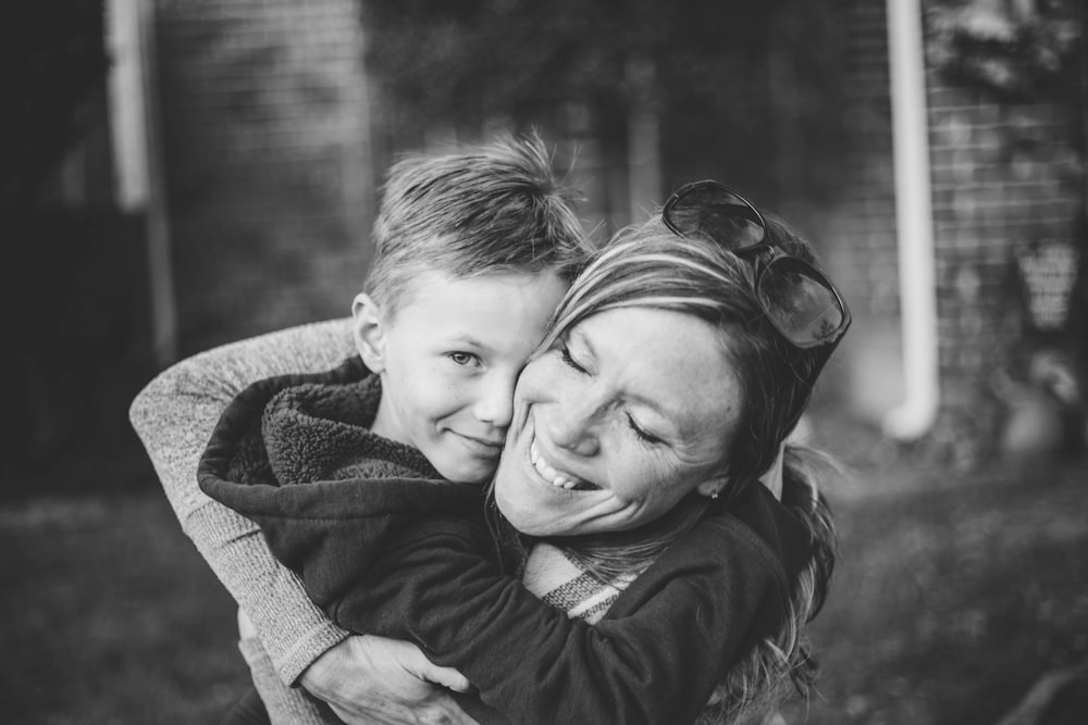 boy hugging woman