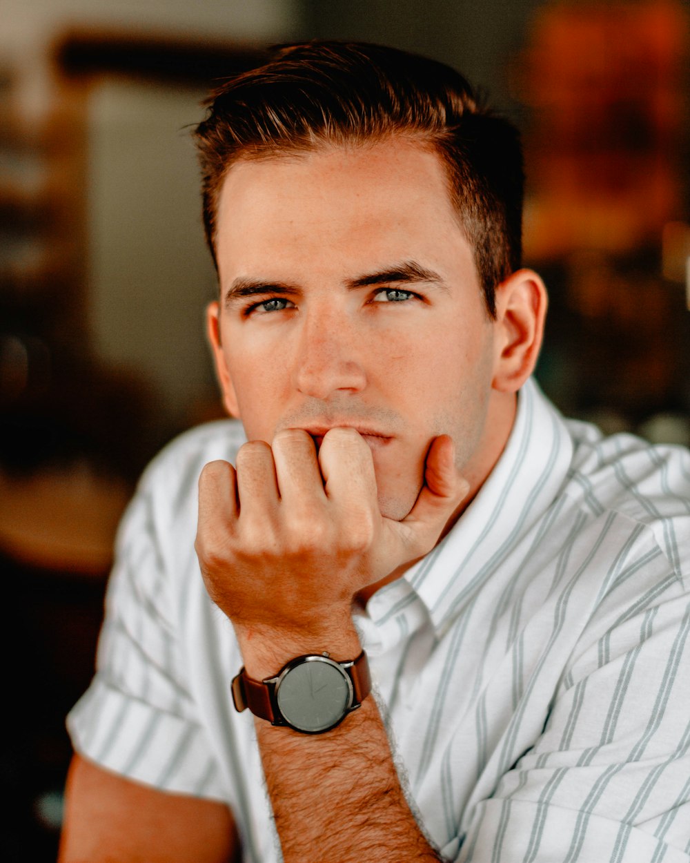 portrait photography of man with chin on palm