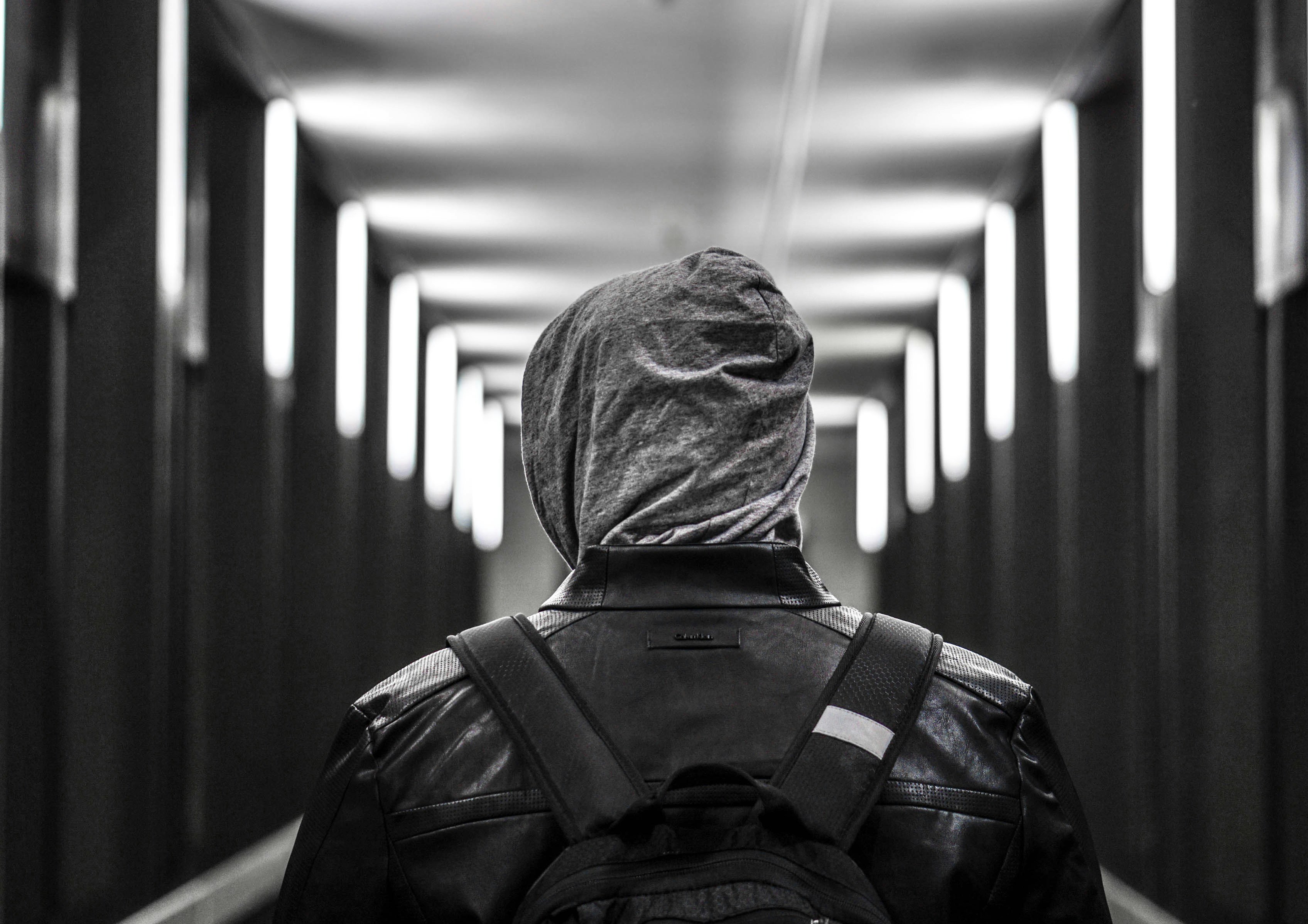 back-view photography of person on hallway