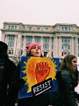 woman holding resist signage