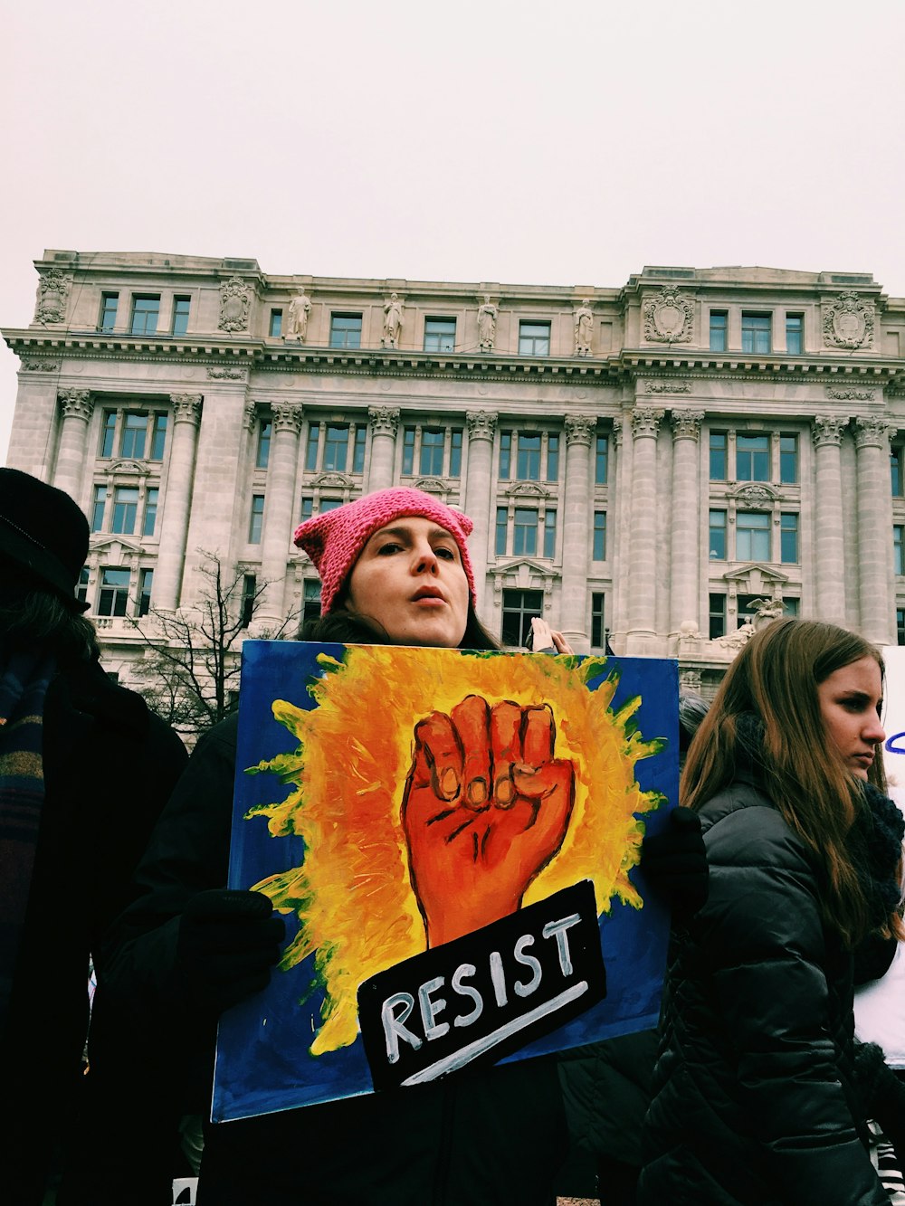 woman holding resist signage