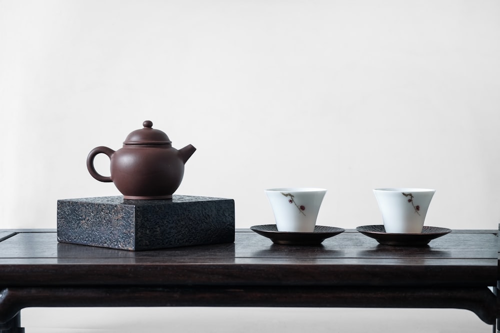 brown teapot on black surface