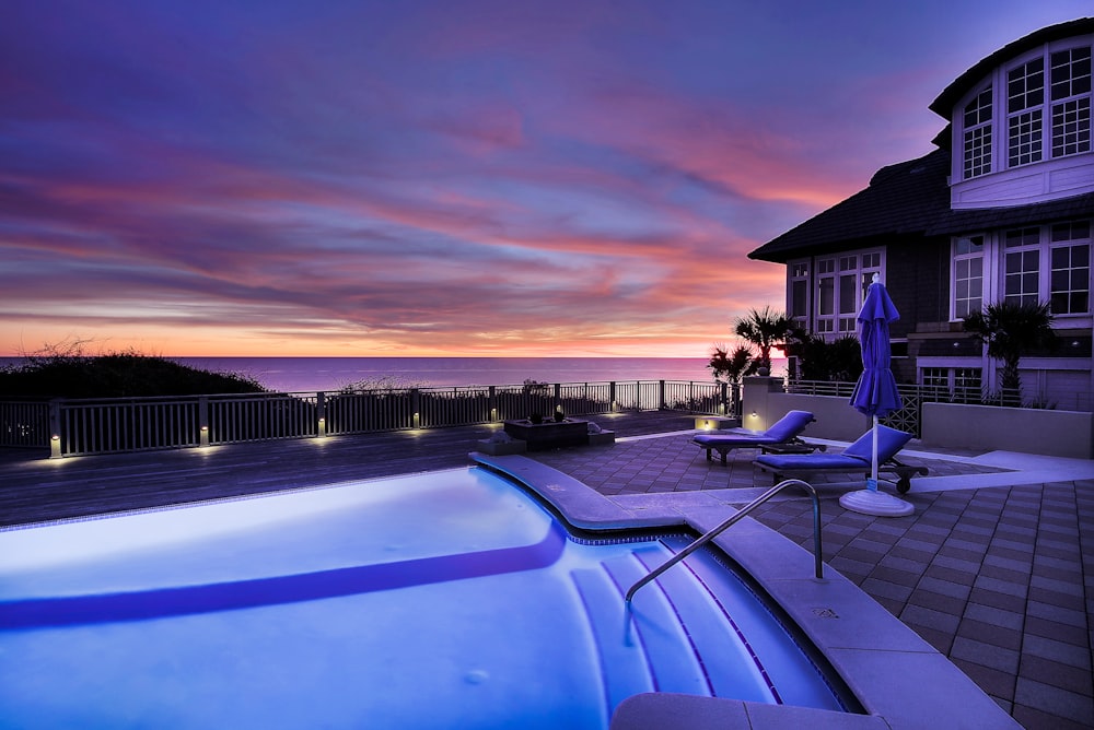 blue swimming pool near house with no people