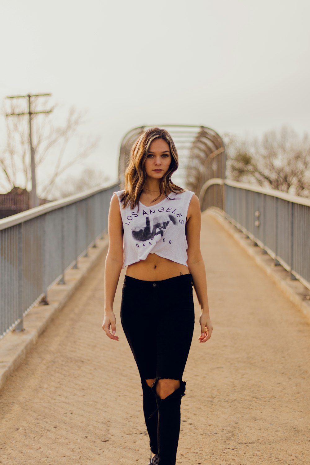 woman standing at middle of bridge