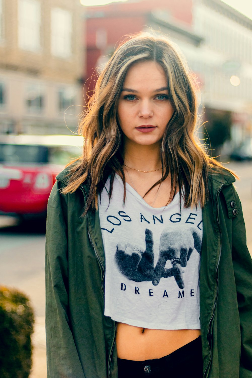 woman standing wearing green jacket