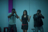 Close-up of a person striking a fun pose inside the 360 video booth surrounded by cameras.