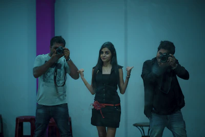 A playful snapshot of a prank setup with hidden cameras and laughing participants.