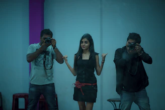Close-up of a person striking a fun pose inside the 360 video booth surrounded by cameras.