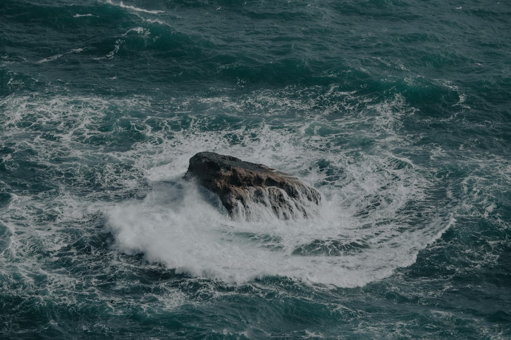 aerial view photography of rock on body of water