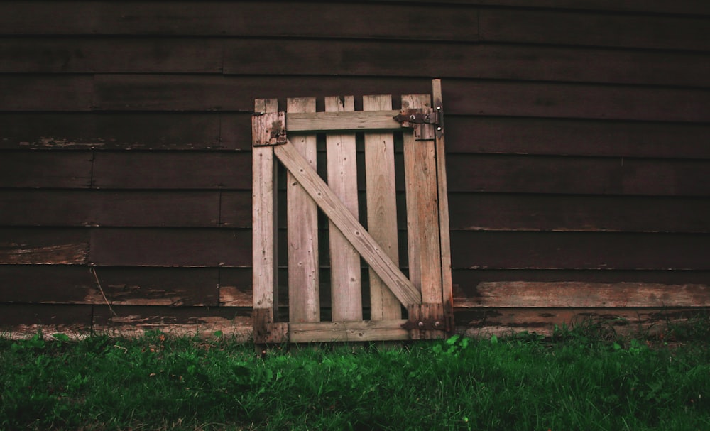 brown wooden fence lean on brown barnhouse during daytime