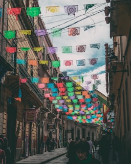 A vibrant street scene in northern Mexico with people discussing politics under colorful banners.