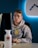 selective focus photography of man sitting on chair facing monitor