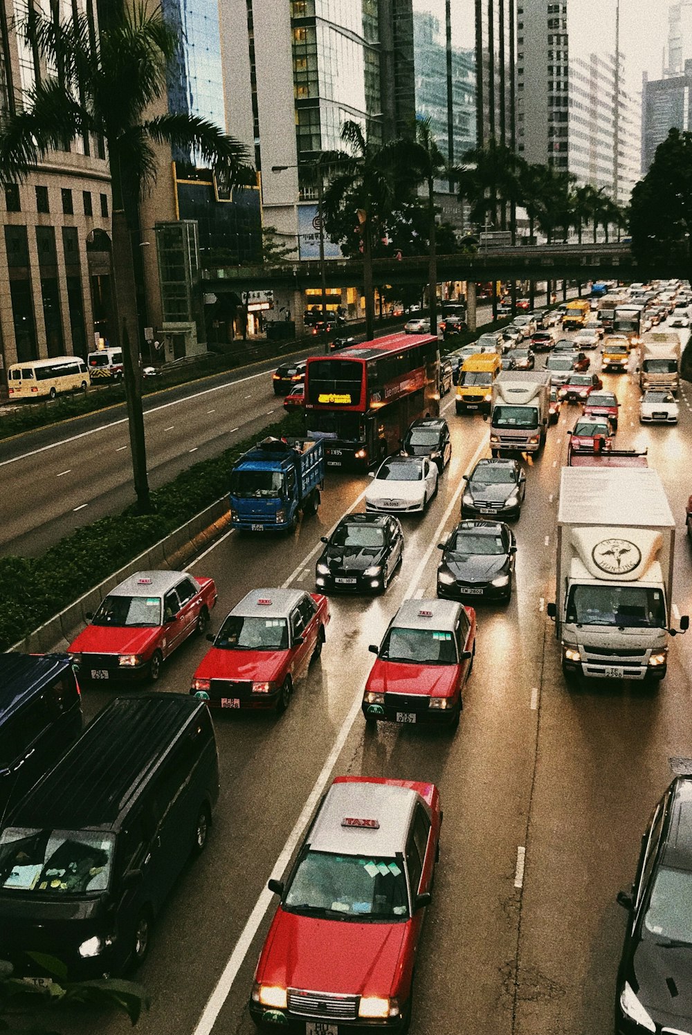 lined of assorted-color vehicles on street during daytime