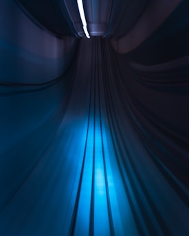 A futuristic motion-activated light strip glowing gently along a hallway ceiling.