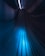 A futuristic hallway with sleek, curved lines and a glowing central strip of blue light extending towards a vanishing point, creating a sense of depth and motion.
