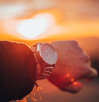 round silver-colored analog watch with link bracelet