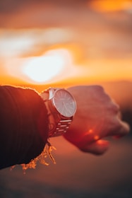 round silver-colored analog watch with link bracelet