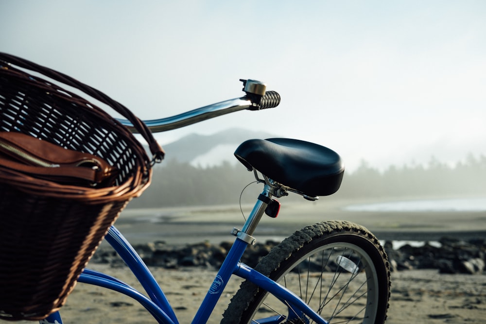 empty blue and black bike with basket at daytime