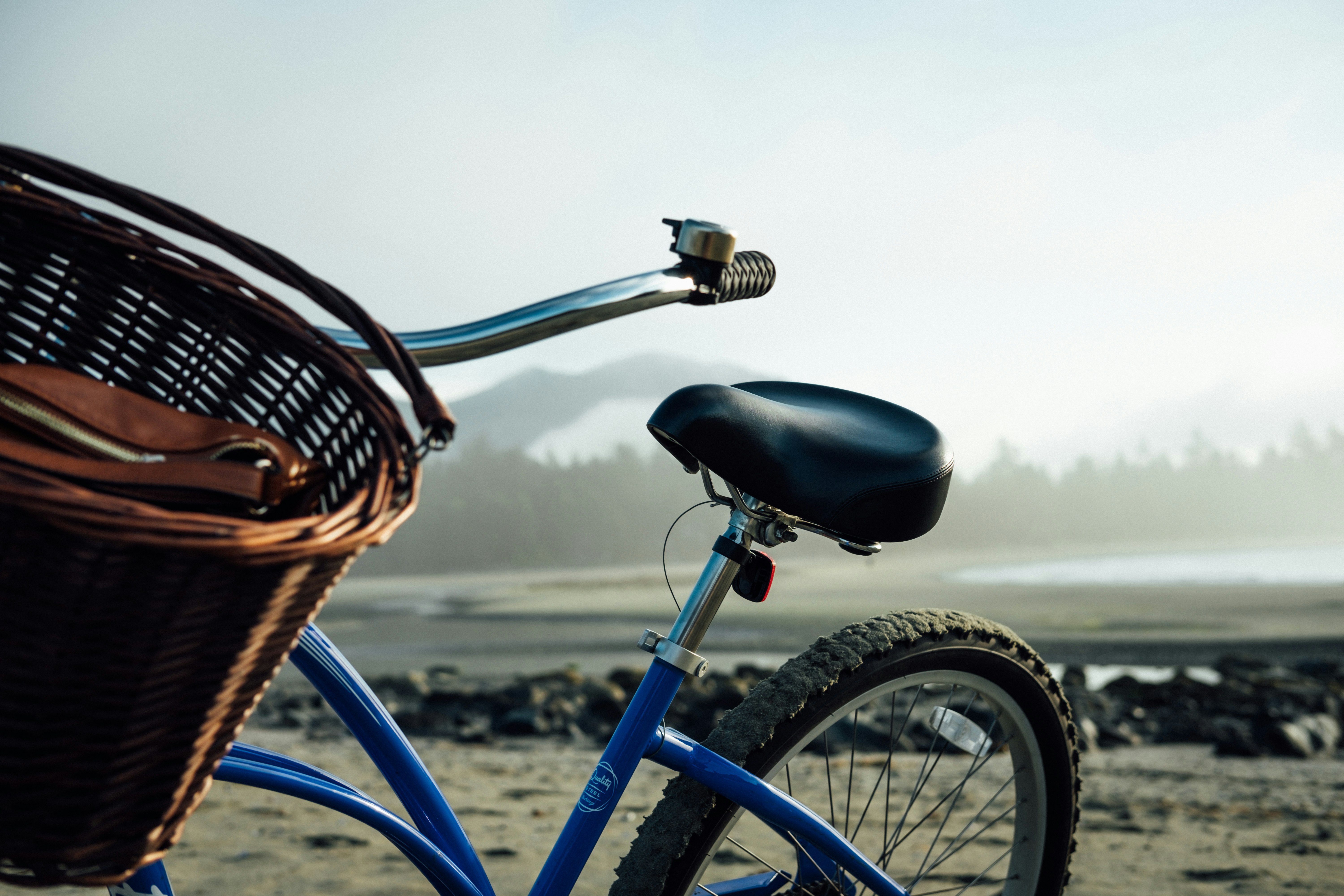 empty blue and black bike with basket at daytime