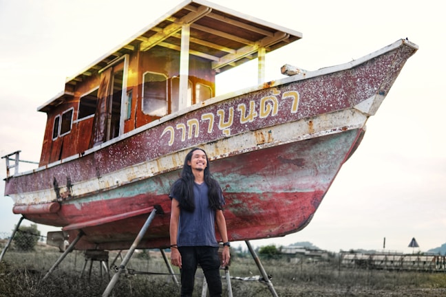 A veteran smiling confidently while preparing a sailboat for the day.