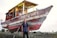 A happy customer standing next to their Aerohull marine boat.