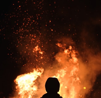 person standing in front of fire