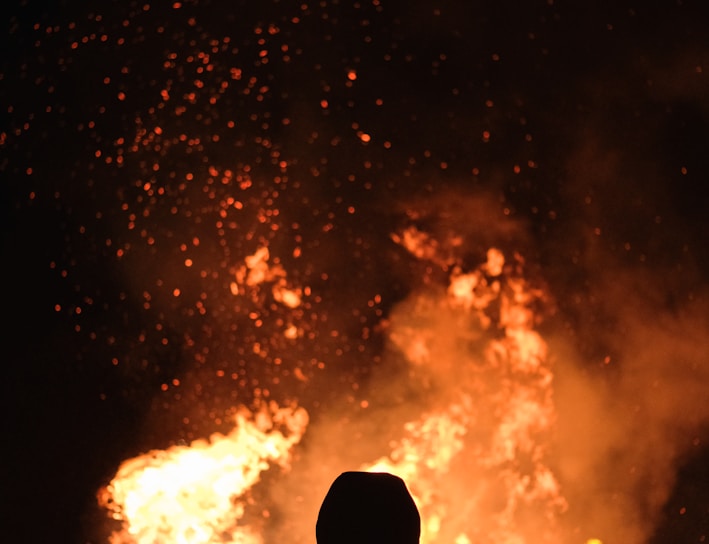 person standing in front of fire