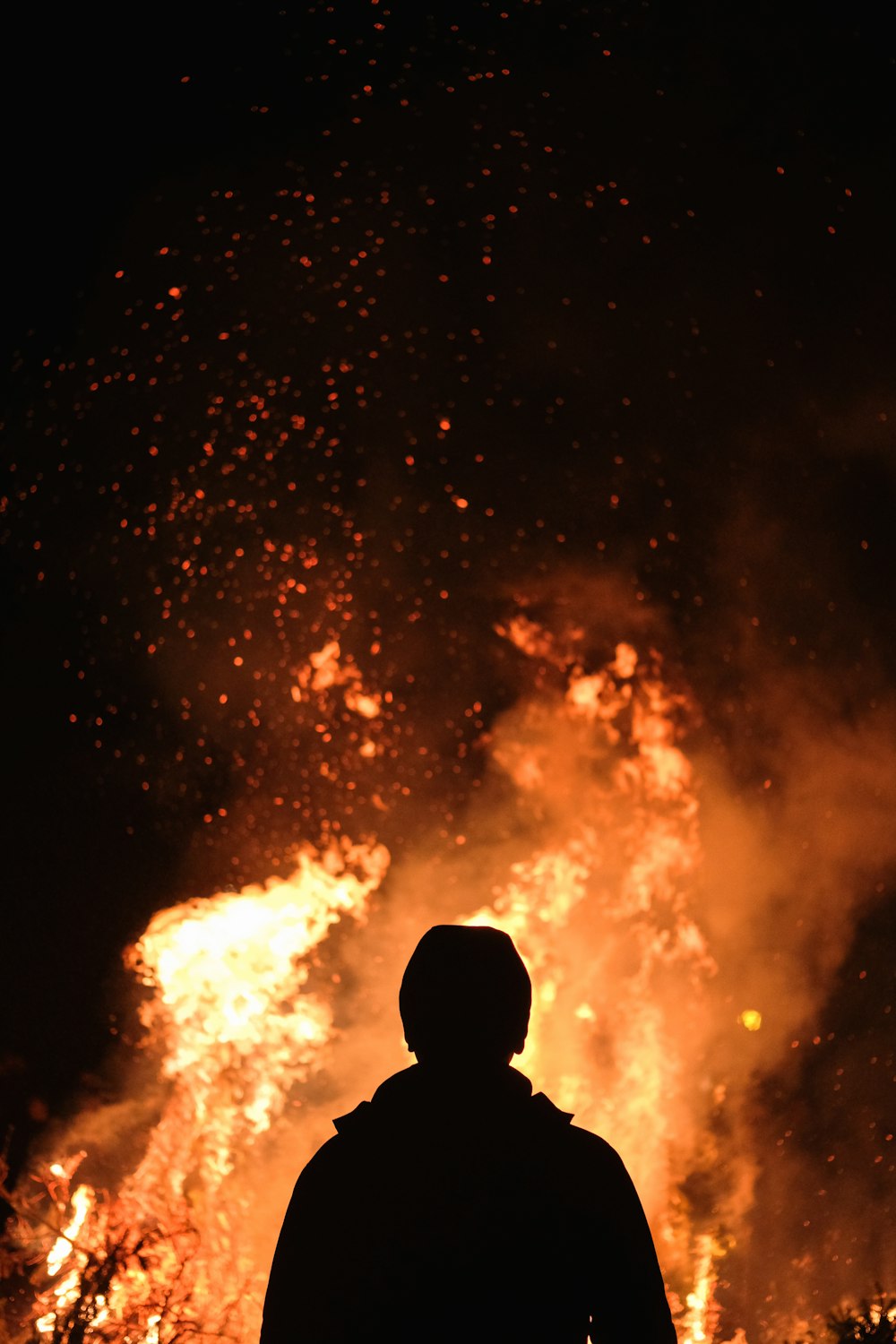 person standing in front of fire