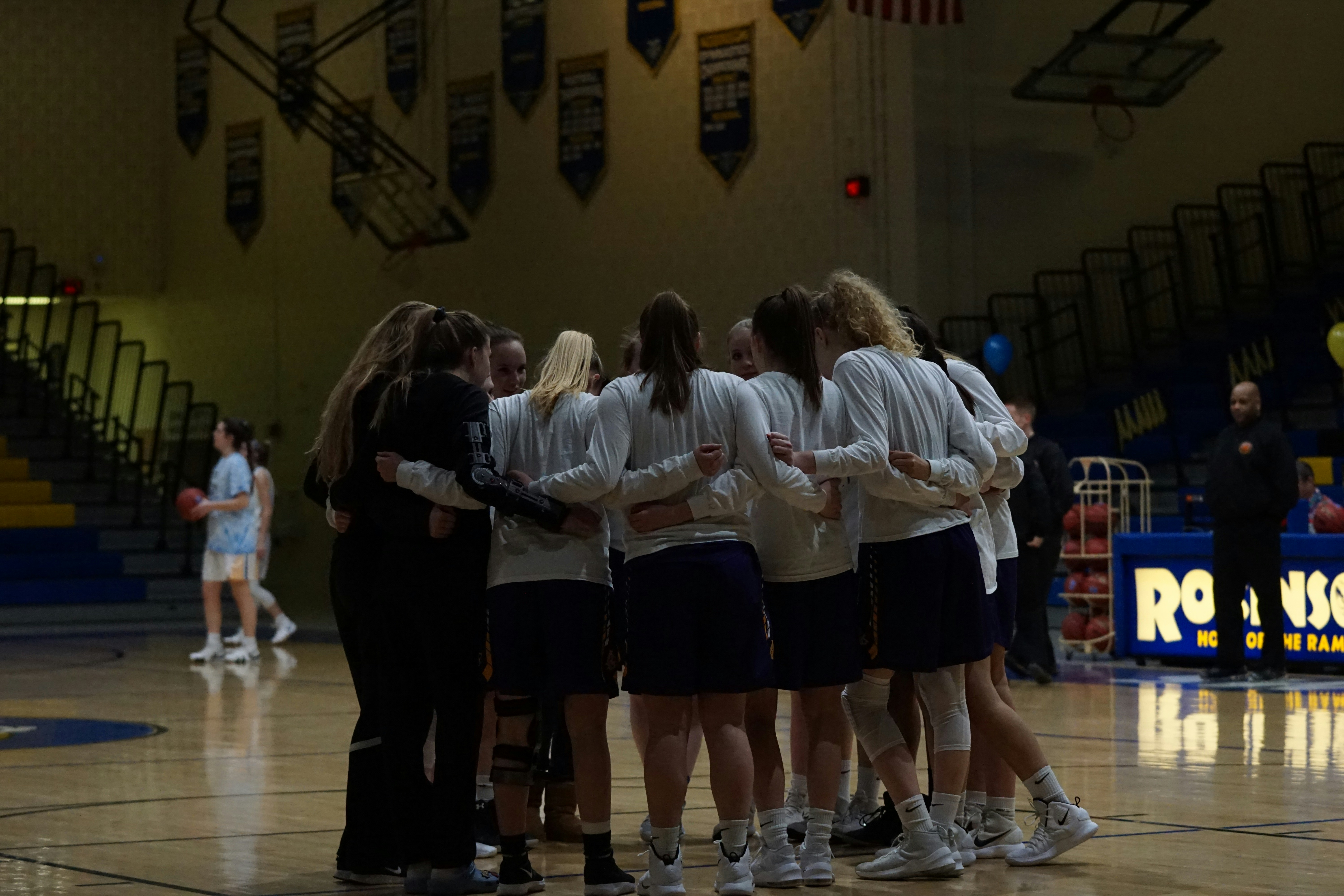 basketball team in middle of basketball court