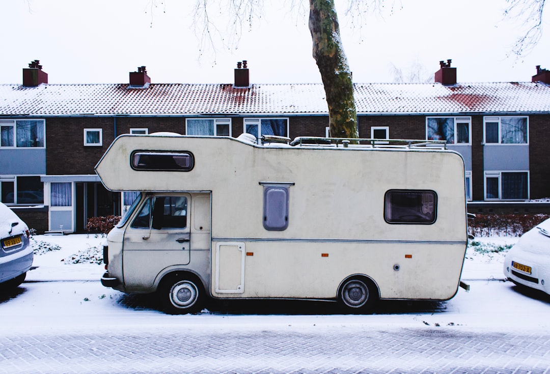 white RV van parked near house