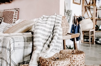 empty sofa with three woven nesting baskets