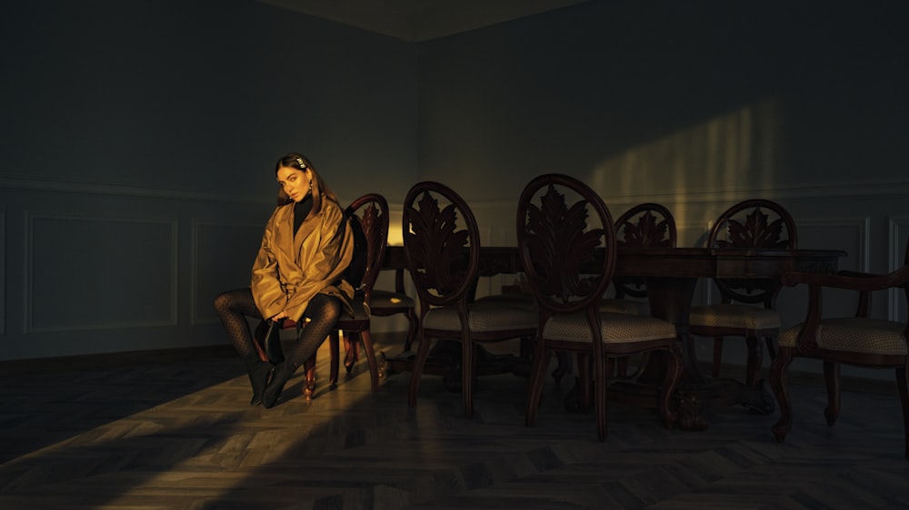 woman sitting on brown wooden chair