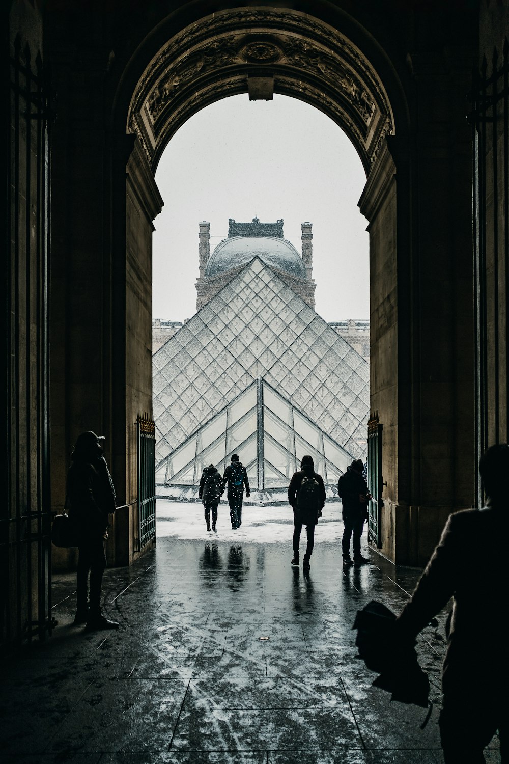 people walking under arch