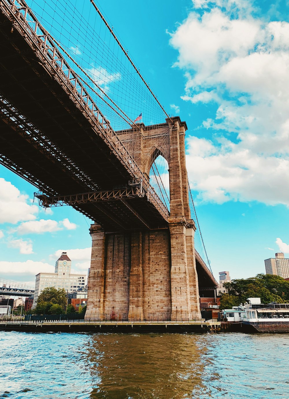 low angle photography of Brooklyn Bridge under white sky