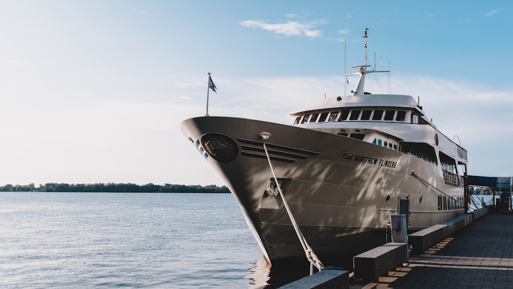 white yacht on dock during daytime