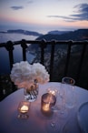 two clear wine glass beside tealight candle on table