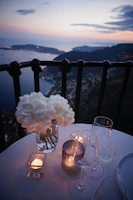 two clear wine glass beside tealight candle on table