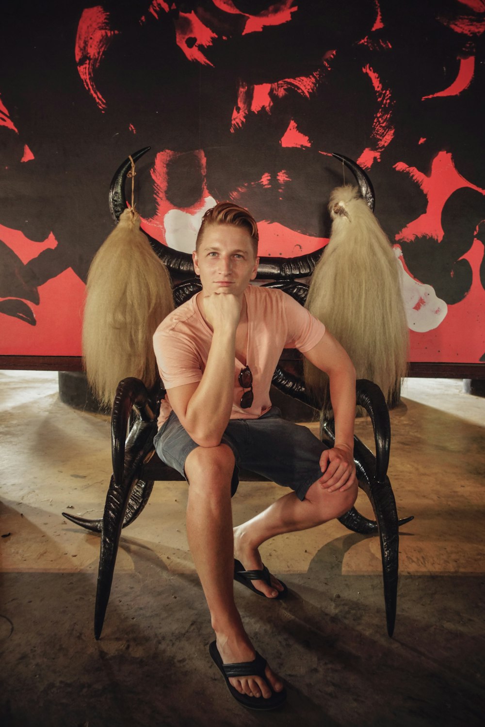 man sitting on black wooden chair