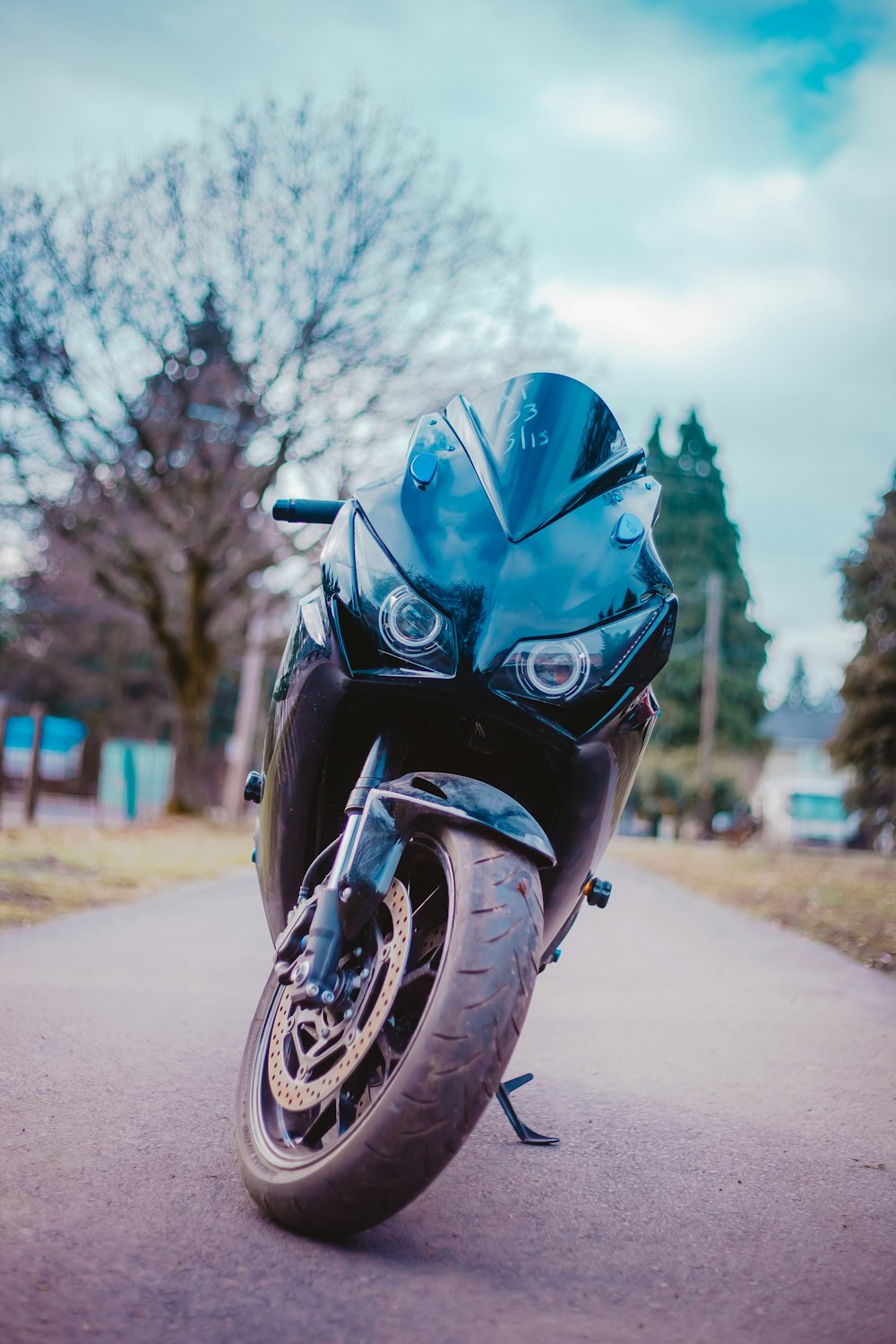 selective focus photography of sports bike parked on road