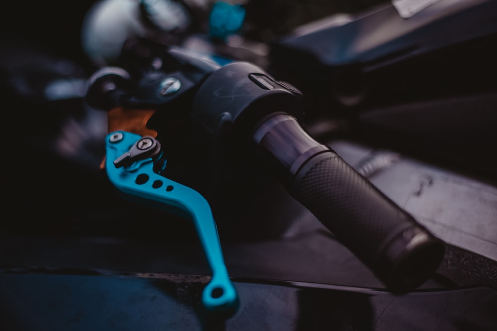 selective focus photography of motorcycle lever and handle bar