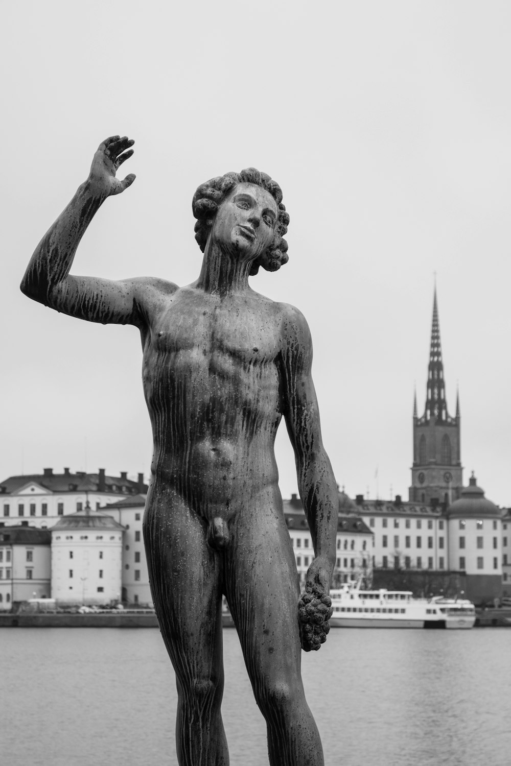 grayscale photography of topless man statue