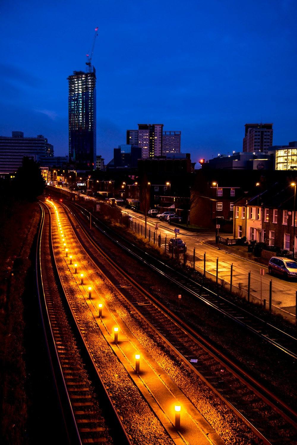 lighted rail near buildings