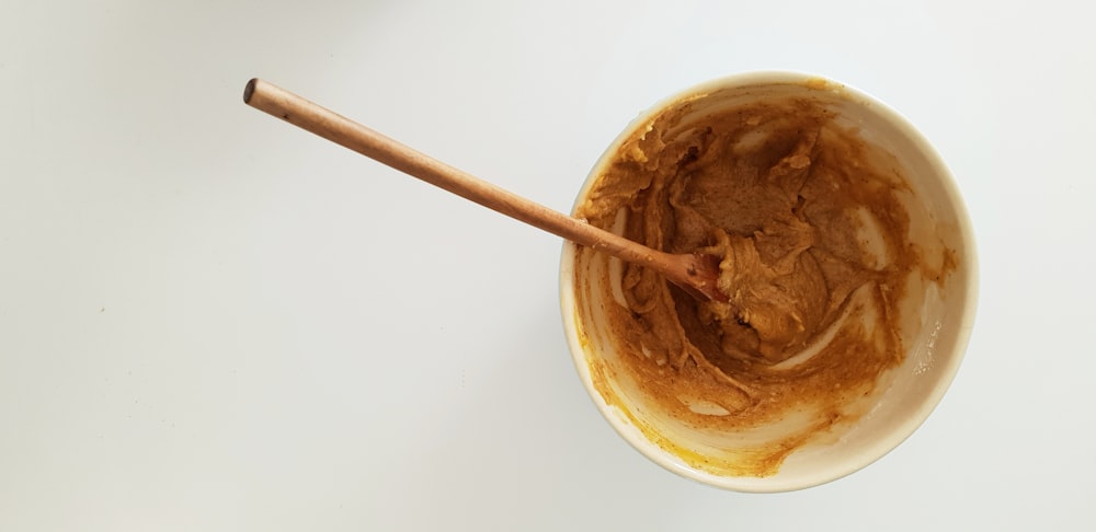 high angle photography of mug filled with peanut butter