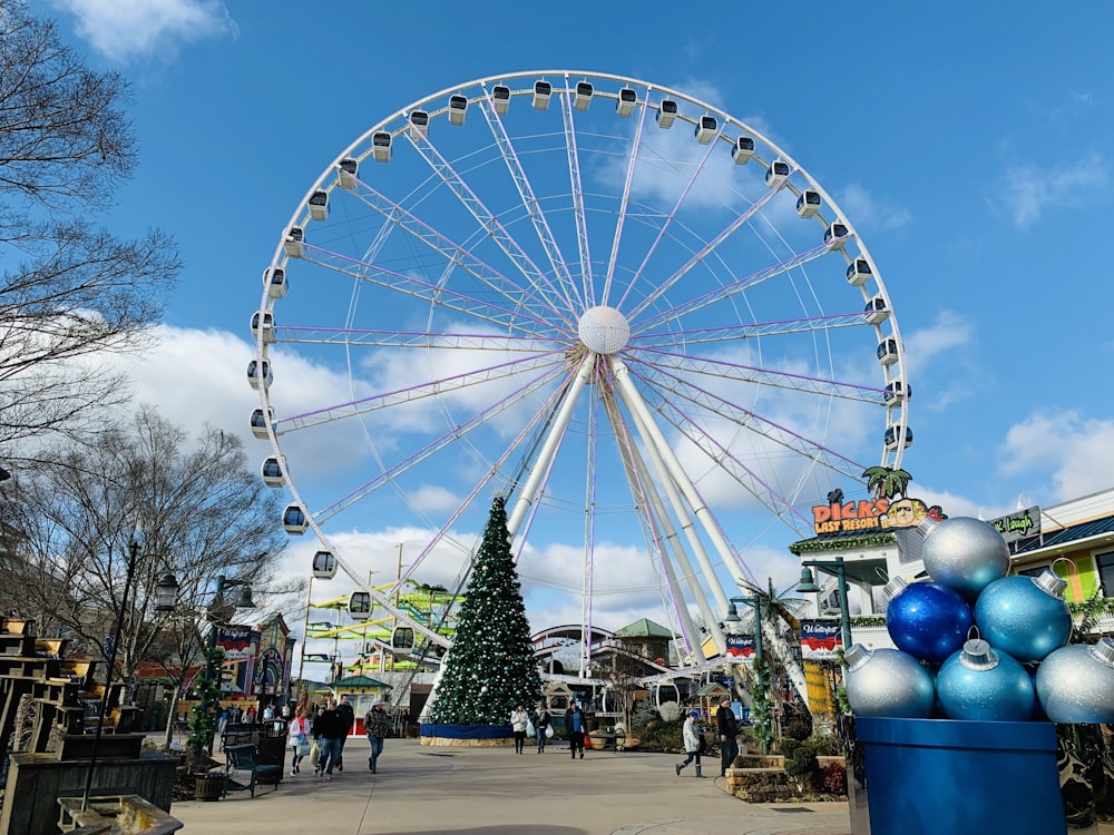 Christmas tree near huge white Ferris wheel