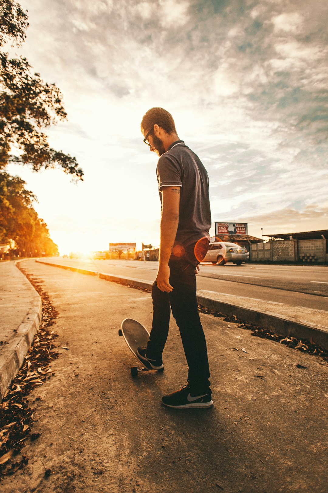 man playing skateboard during golden hour