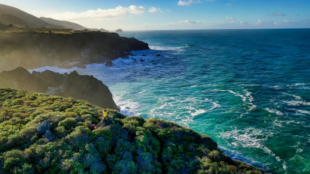 green rocky cliff overlooking the sea