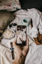 A stylish flat lay of a smartphone displaying the glute workout app next to healthy meal ingredients on a beige background.