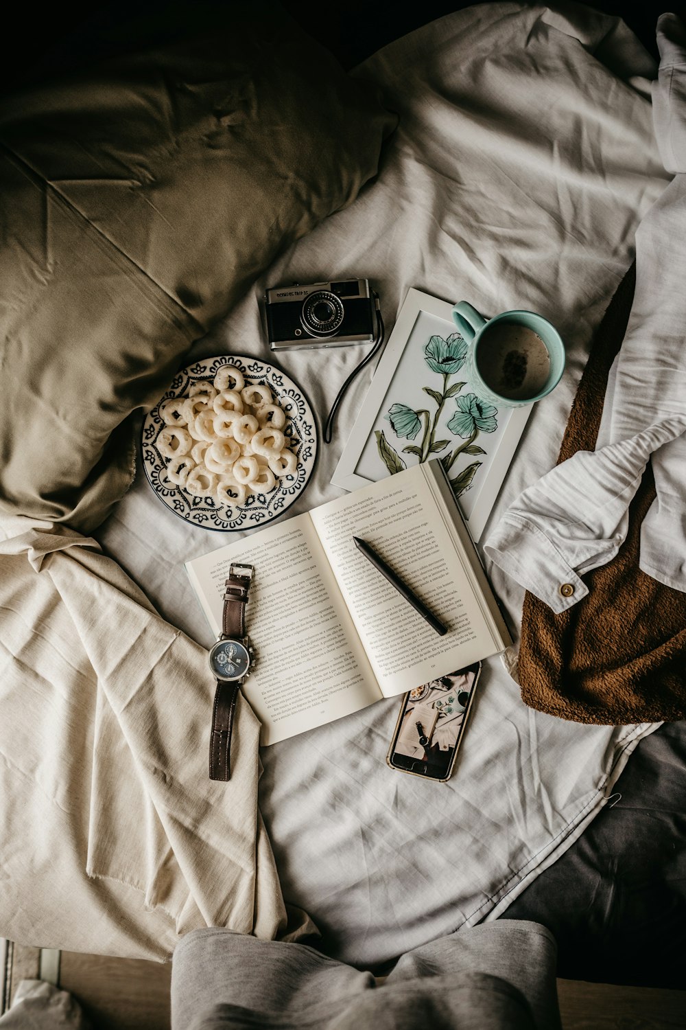 mug of coffee with cereal on bed