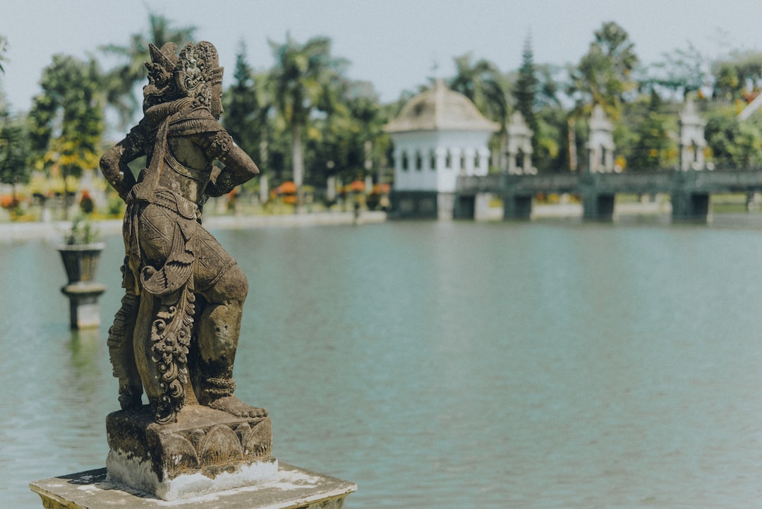 selective focus photography of person figurine on body of water